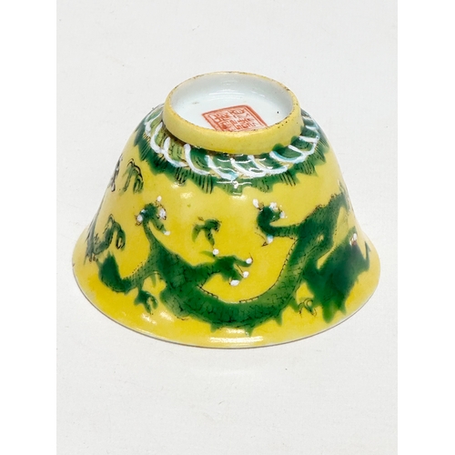 16 - A 19th century Chinese emperor Tongzhi (1856-1875) yellow ground porcelain rice bowl with green enam... 