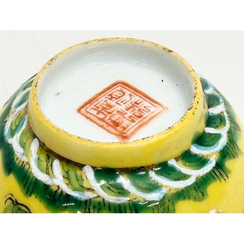 16 - A 19th century Chinese emperor Tongzhi (1856-1875) yellow ground porcelain rice bowl with green enam... 