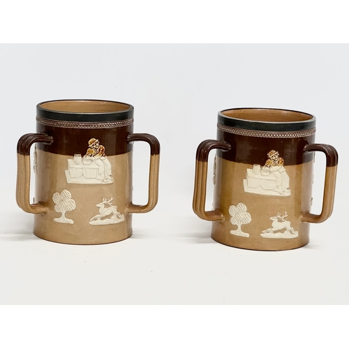 84 - A pair of large early 20th century Royal Doulton Lambeth stoneware Tyg tankard mugs. Silver (plated)... 