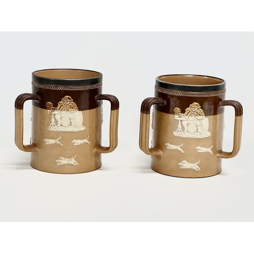 84 - A pair of large early 20th century Royal Doulton Lambeth stoneware Tyg tankard mugs. Silver (plated)... 