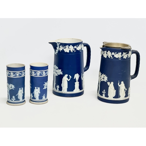 88 - 4 pieces of late 19th century Wedgwood Jasper Ware. A pair of jugs 17x19.5cm. A pair of cylinder vas... 