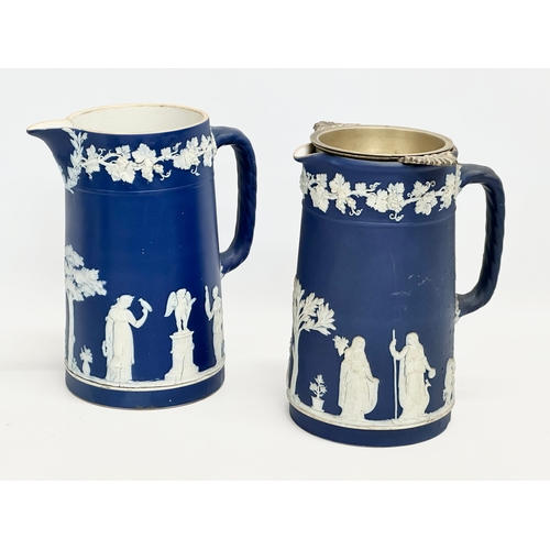 88 - 4 pieces of late 19th century Wedgwood Jasper Ware. A pair of jugs 17x19.5cm. A pair of cylinder vas... 