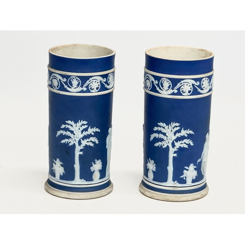 88 - 4 pieces of late 19th century Wedgwood Jasper Ware. A pair of jugs 17x19.5cm. A pair of cylinder vas... 