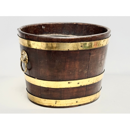 22 - A George III brass bound wine cooler with lion ring handles and original liner. Circa 1780-1790. 43x... 