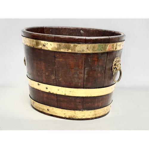 22 - A George III brass bound wine cooler with lion ring handles and original liner. Circa 1780-1790. 43x... 