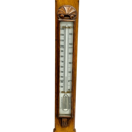 26 - A large Victorian oak stick barometer by F.M. Moore of Belfast and Dublin. 107cm