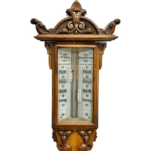 26 - A large Victorian oak stick barometer by F.M. Moore of Belfast and Dublin. 107cm