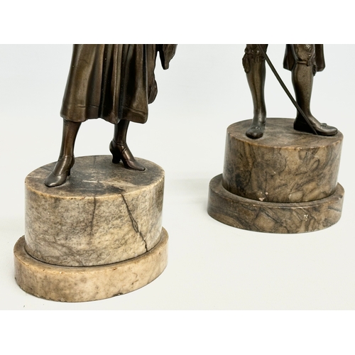 27 - A pair of 1930’s Art Deco spelter and faux ivory figures on marble bases. 26.5cm