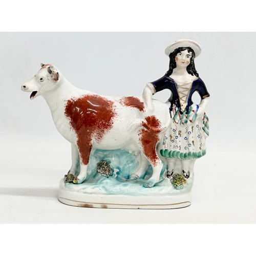 198 - A mid 19th century Staffordshire Cow Creamer. 21x18.5cm