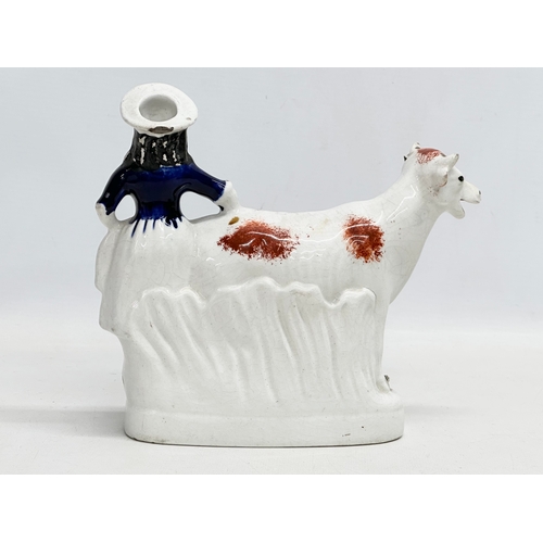 198 - A mid 19th century Staffordshire Cow Creamer. 21x18.5cm