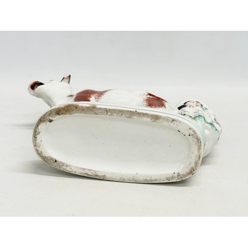 198 - A mid 19th century Staffordshire Cow Creamer. 21x18.5cm