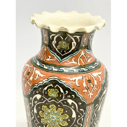 127 - A mid 19th century Iznik glazed stoneware vase with frilled rim. 12.5x21cm