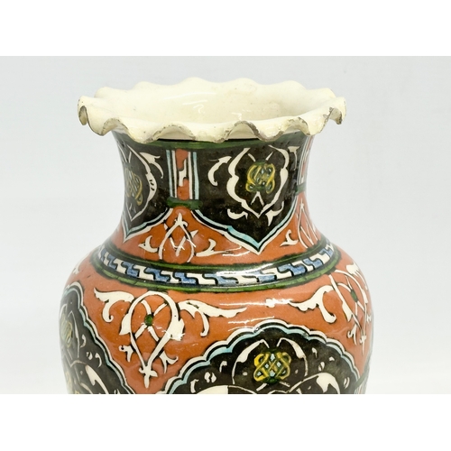 127 - A mid 19th century Iznik glazed stoneware vase with frilled rim. 12.5x21cm