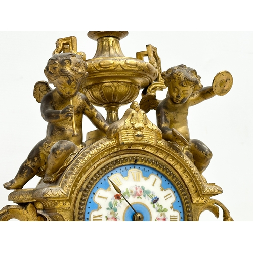 115 - A mid 19th century Henry Marc gilt brass mantle clock, decorated with cherubs and hand painted porce... 