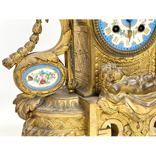 115 - A mid 19th century Henry Marc gilt brass mantle clock, decorated with cherubs and hand painted porce... 