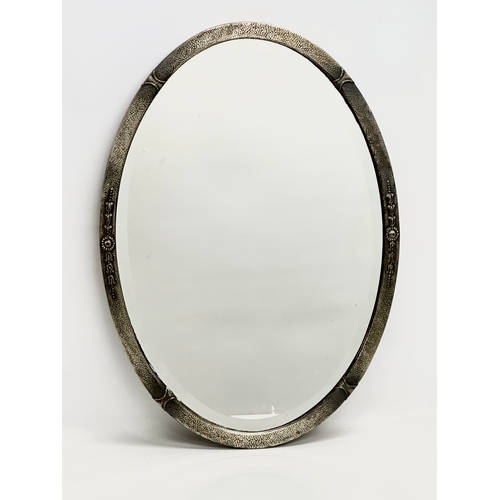 158 - An early 20th century Arts & Crafts bevelled mirror. 50x70cm