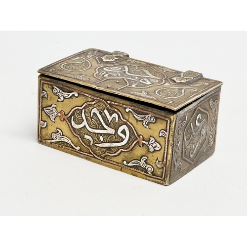 43 - A 19th century Cairo Ware silver and copper inlaid brass trinket box. 9.5x6x4.5cm