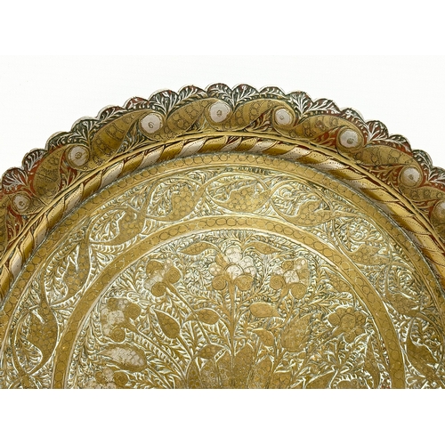 215 - 2 late 19th century Middle Eastern brass trays. 32x33cm