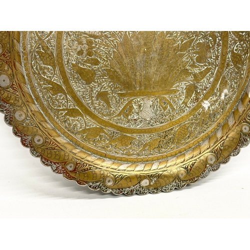 215 - 2 late 19th century Middle Eastern brass trays. 32x33cm