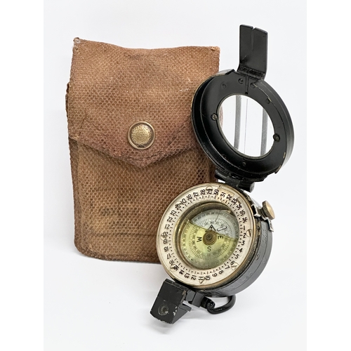 167 - A British WWII compass with case. Stamped 1944.