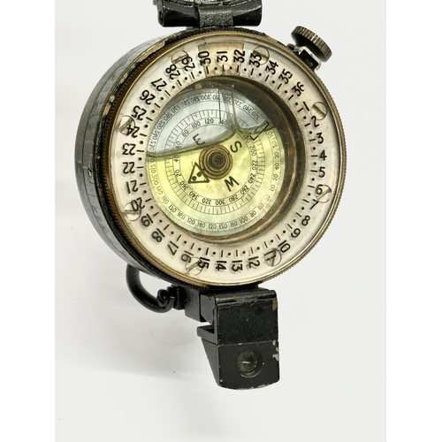 167 - A British WWII compass with case. Stamped 1944.