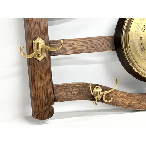 246 - An early 20th century oak wall hanging barometer/hat and coat rack. 78x43cm