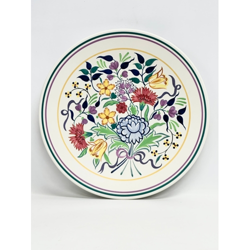 259 - A large Poole Pottery charger designed by Gwen Haskins. 35cm