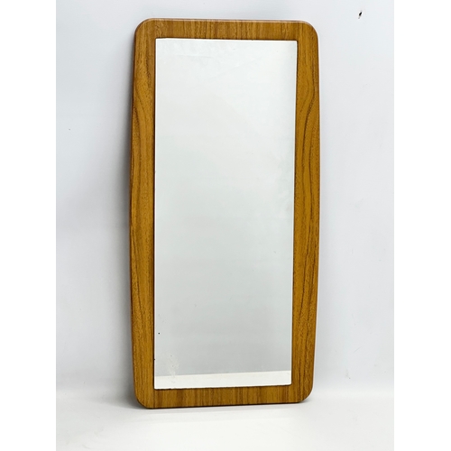 145D - A 1970’s Mid Century mirror. 39x76.5cm