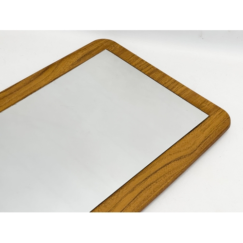 145D - A 1970’s Mid Century mirror. 39x76.5cm