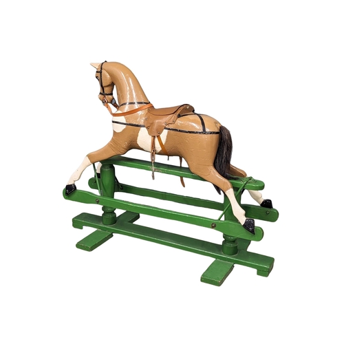 41 - A large vintage child's wooden rocking horse. 129x110cm