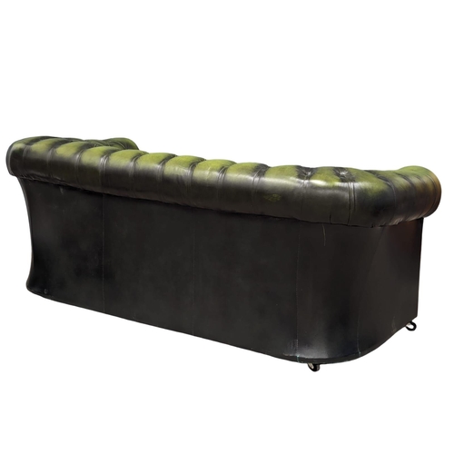 888 - A deep button leather 3 seater sofa. 182cm