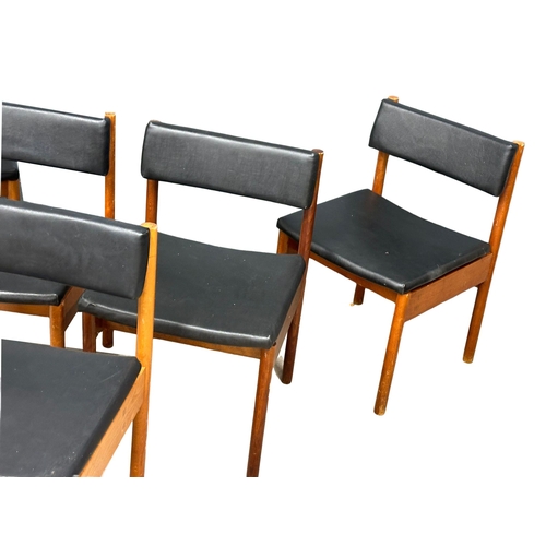 890 - A set of 5 Mid Century dining chairs with black vinyl seats and backs. Stamped crows feet.