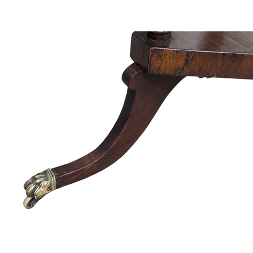 928 - A Regency rosewood lamp table on brass lion paw feet, circa 1810. 50.5x72cm