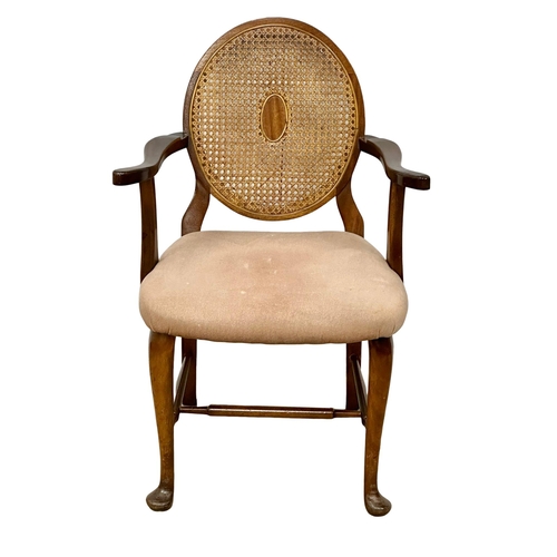 930 - A vintage armchair with bergere back.