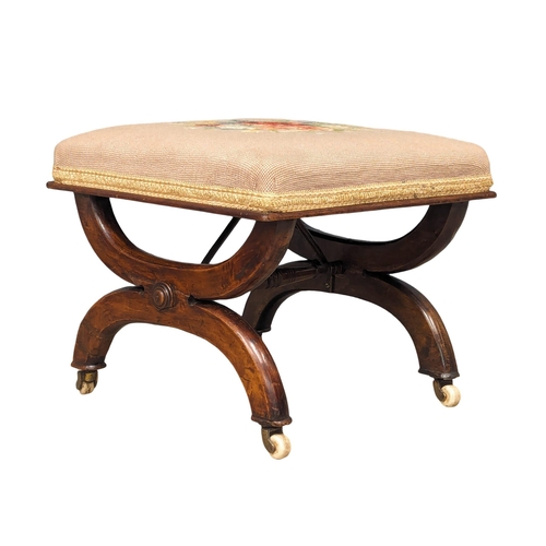 932 - A Victorian mahogany footstool with tapestry top. Circa 1860. 42x36cm