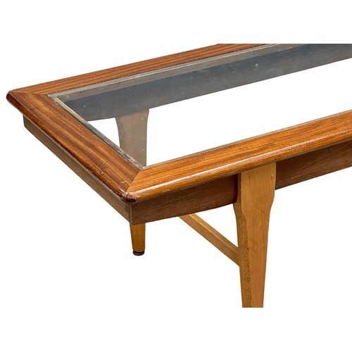 948 - A Mid Century teak coffee table with glass top. 121x46x39cm