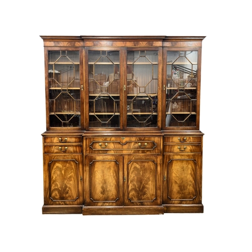 958 - A large Georgian style mahogany secretaire breakfront bookcase with astragal glazed doors and adjust... 