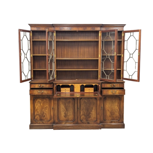 958 - A large Georgian style mahogany secretaire breakfront bookcase with astragal glazed doors and adjust... 