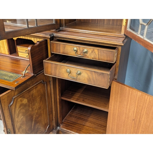 958 - A large Georgian style mahogany secretaire breakfront bookcase with astragal glazed doors and adjust... 