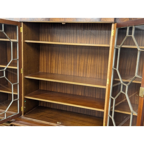 958 - A large Georgian style mahogany secretaire breakfront bookcase with astragal glazed doors and adjust... 