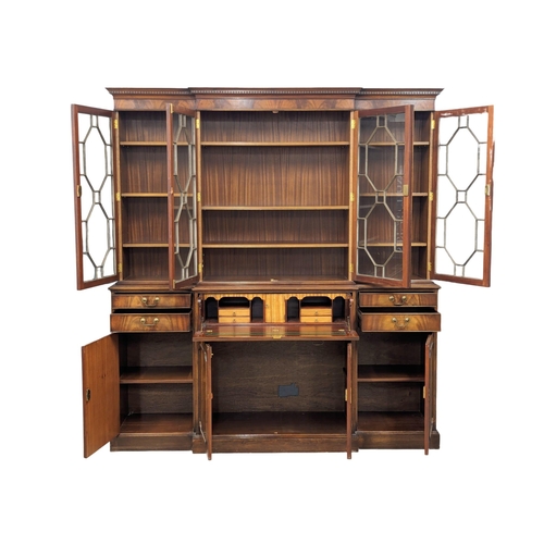 958 - A large Georgian style mahogany secretaire breakfront bookcase with astragal glazed doors and adjust... 