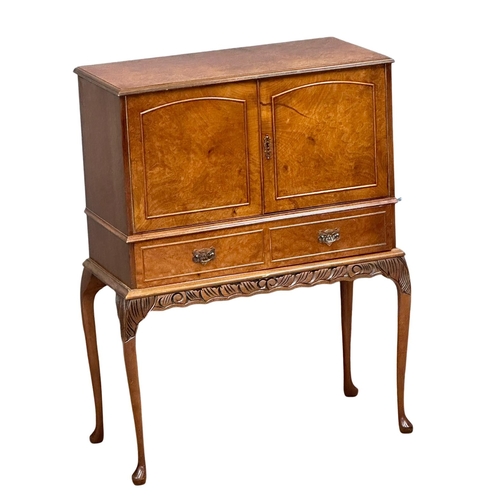 960 - A 1950’s Georgian style Burr Walnut cocktail cabinet with Queen Anne legs. 80x39x103cm