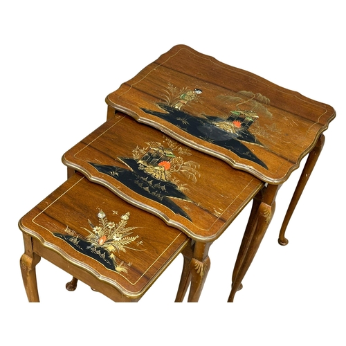 962 - A vintage coffee table and matching nest of tables with Chinoiserie decoration.