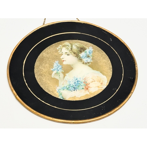 48 - A pair of early 20th century paintings on prints of ladies with gilded metal frames. Circa 1900-1910... 