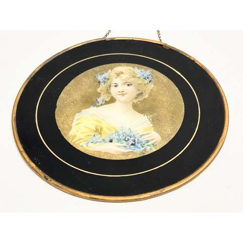 48 - A pair of early 20th century paintings on prints of ladies with gilded metal frames. Circa 1900-1910... 