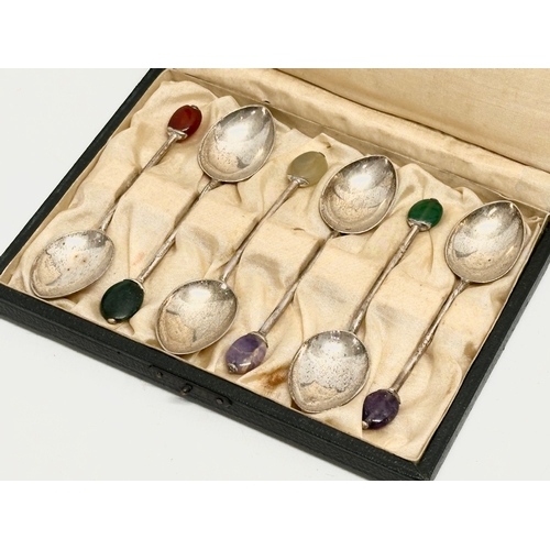 421 - A set of 6 1920s Liberty & Co silver cocktail spoons with stone set handles in original case. Amethy... 