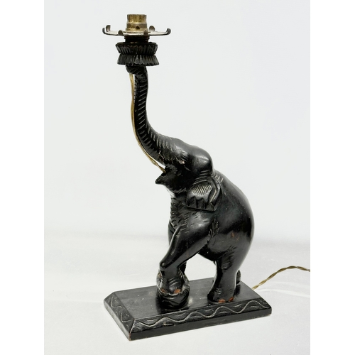 52 - A pair of large early/mid 20th century carved  ebonised teak elephant table lamps. 21x12x42cm