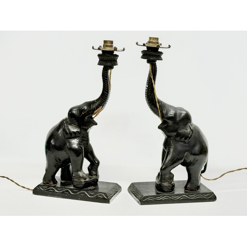 52 - A pair of large early/mid 20th century carved  ebonised teak elephant table lamps. 21x12x42cm