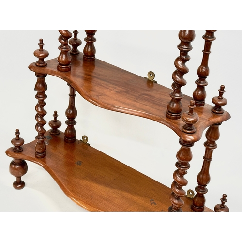 57 - A Victorian walnut 3 tier tabletop/wall hanging whatnot with Barley Twist supports. 56x19x65cm