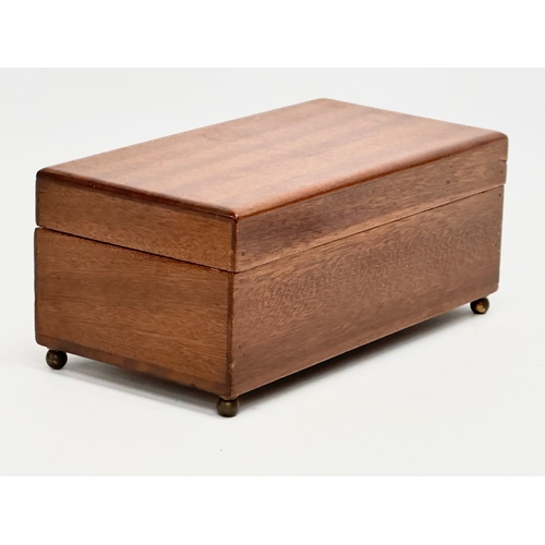 393 - An early 20th century mahogany musical storage box. Working. 19.5x10.5x8.5cm.